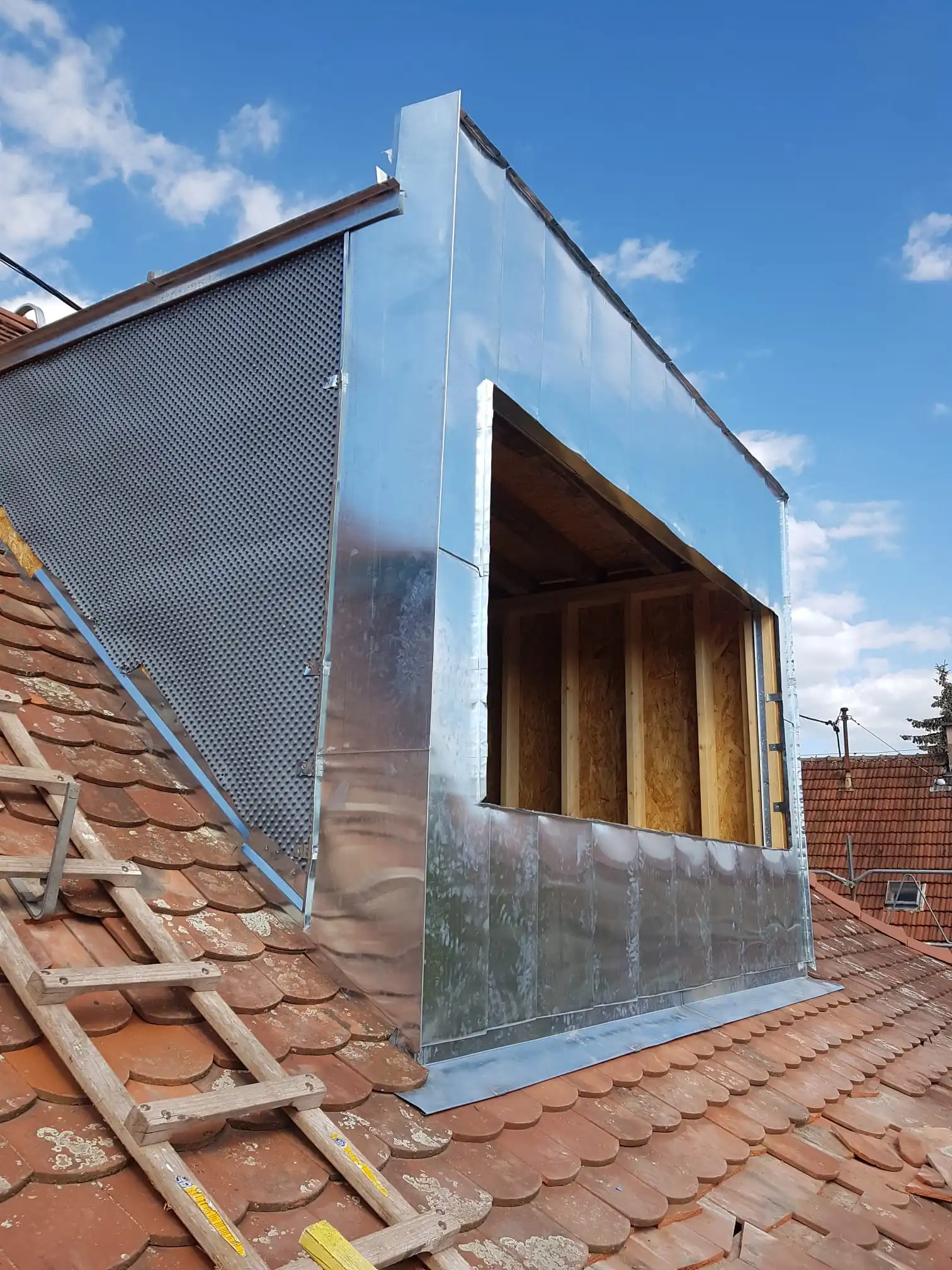 Laurent Roth working on a roof